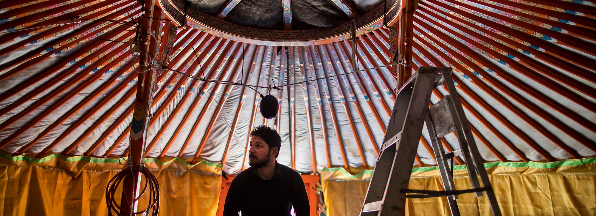 image of a man setting up a tent on the inside