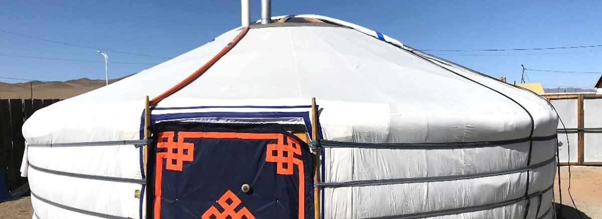 image of the outside of a tent building structure in the bright sun